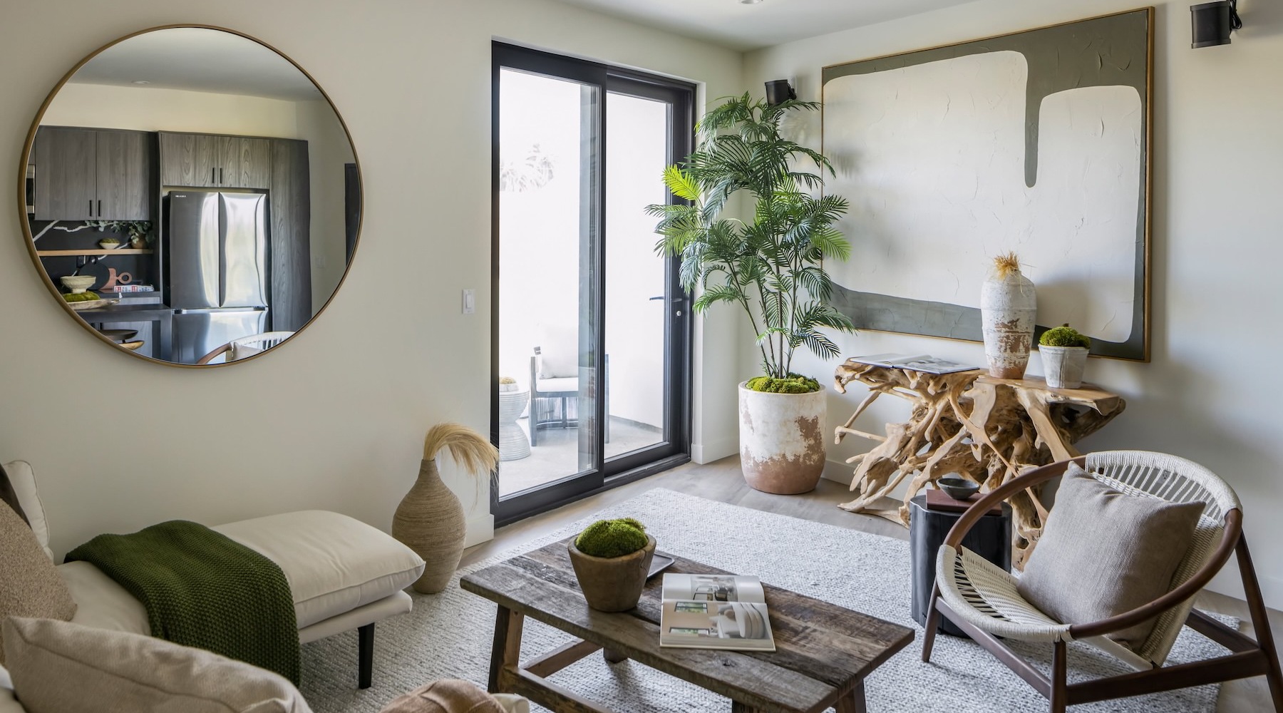 a living room with a mirror and a table