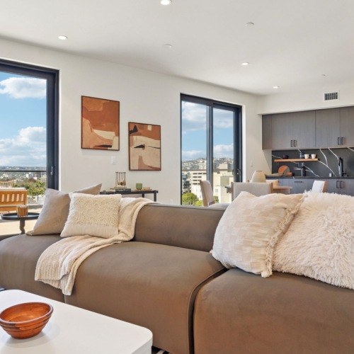 a living room with a mirror and a table